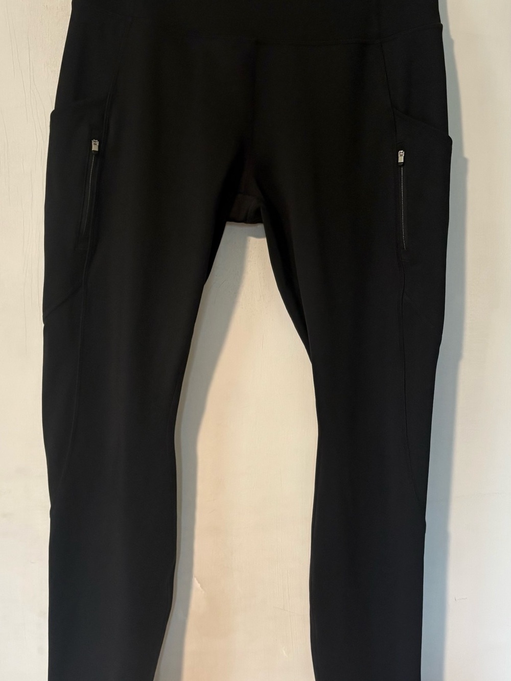 Black high-waisted athletic leggings by Athleta.